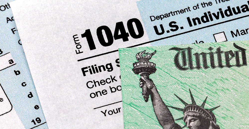 tax return IRS form 1040 and U.S. Treasury tax refund check